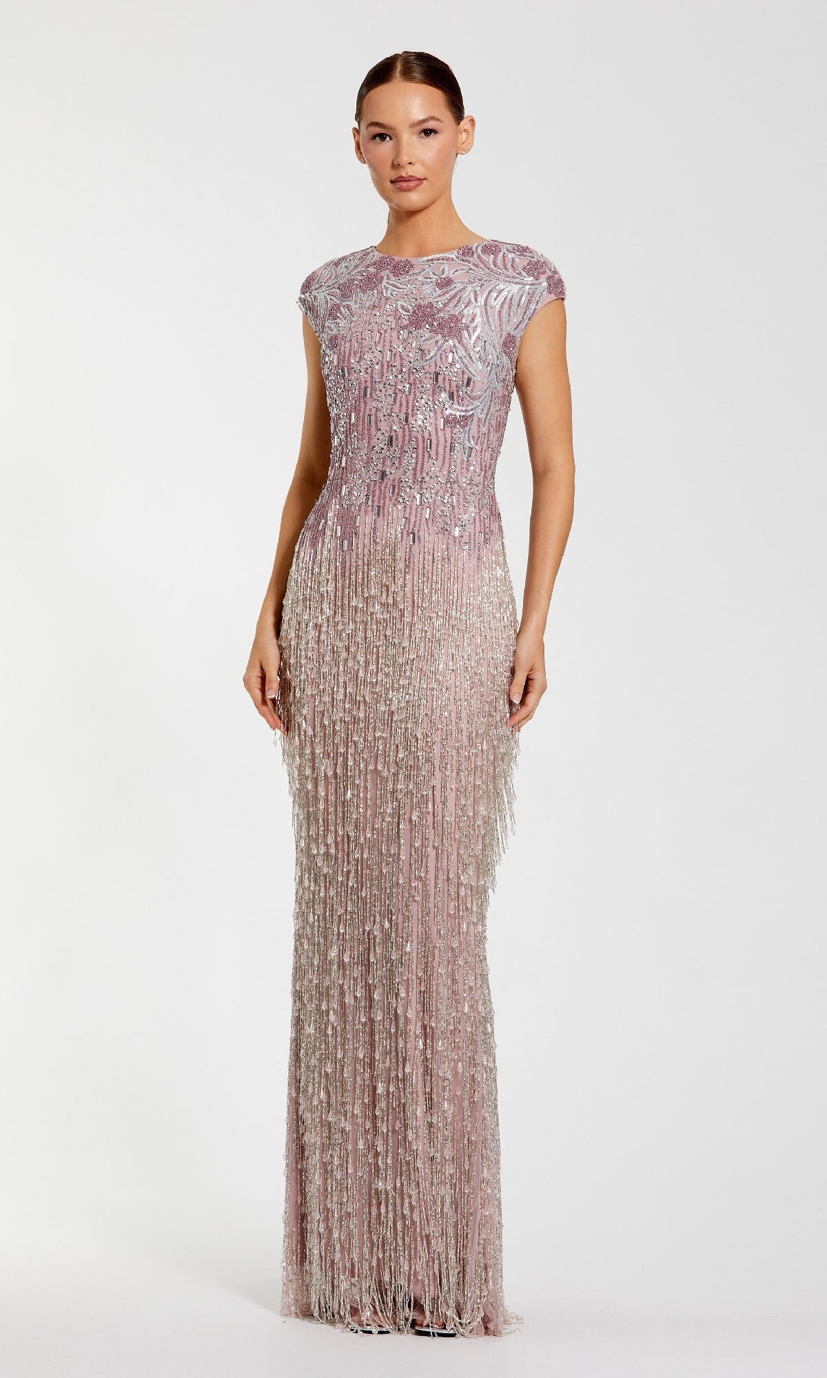 A woman poses against a plain white background wearing the Beaded Long Lilac Formal Dress: Mac Duggal 6169, a floor-length gown with silver beaded embellishments and fringe detailing.